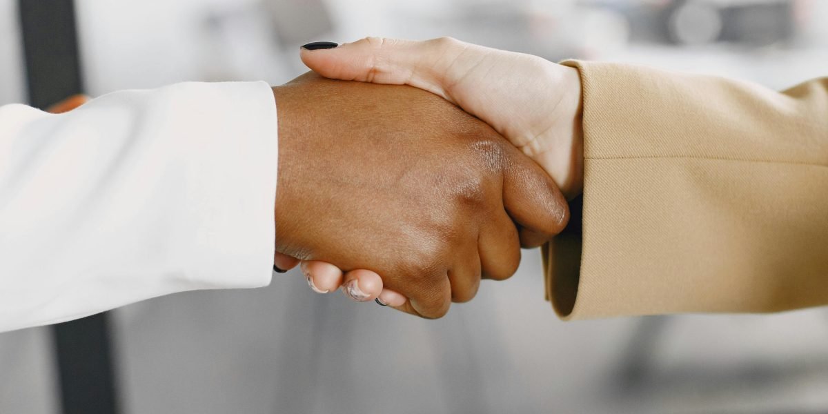 Professionals shaking hands, symbolizing a successful partnership or agreement in a business context.