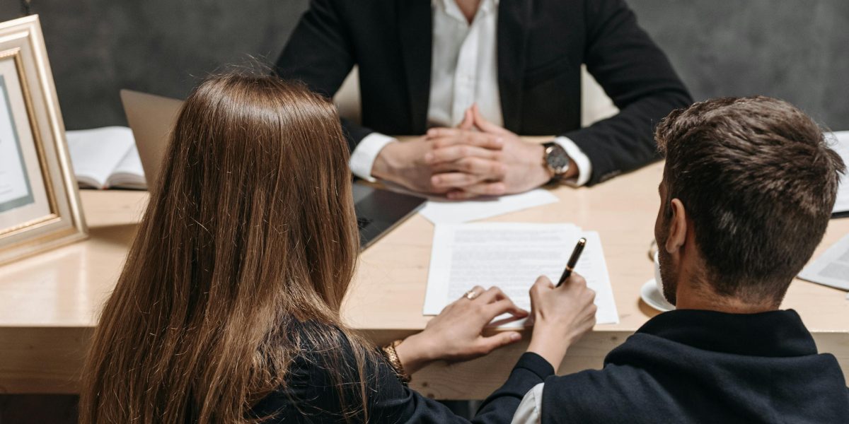 Professionals reviewing legal documents, emphasizing the importance of written agreements in real estate transactions.