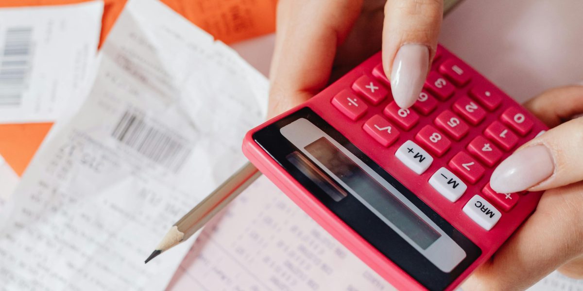 A person carefully examining an invoice, representing the need for clients to understand all charges, including VAT.