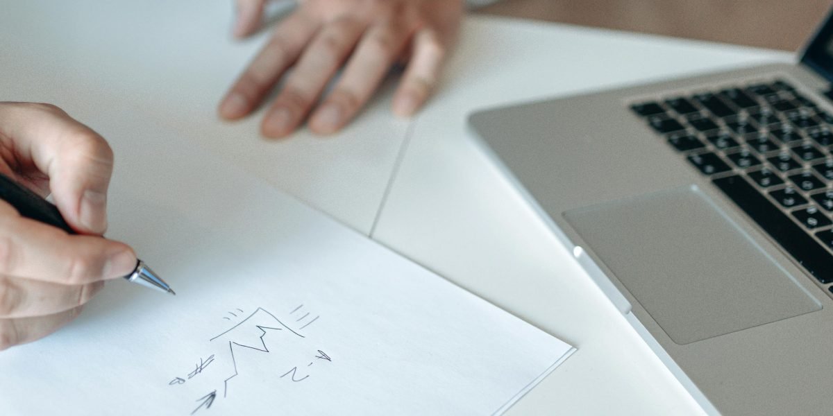 An individual thoughtfully considering investment opportunities and risks in a formal setting.