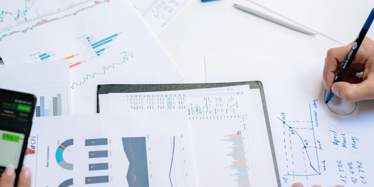 Professionals collaborating on market research, analyzing data and trends for investment decisions.