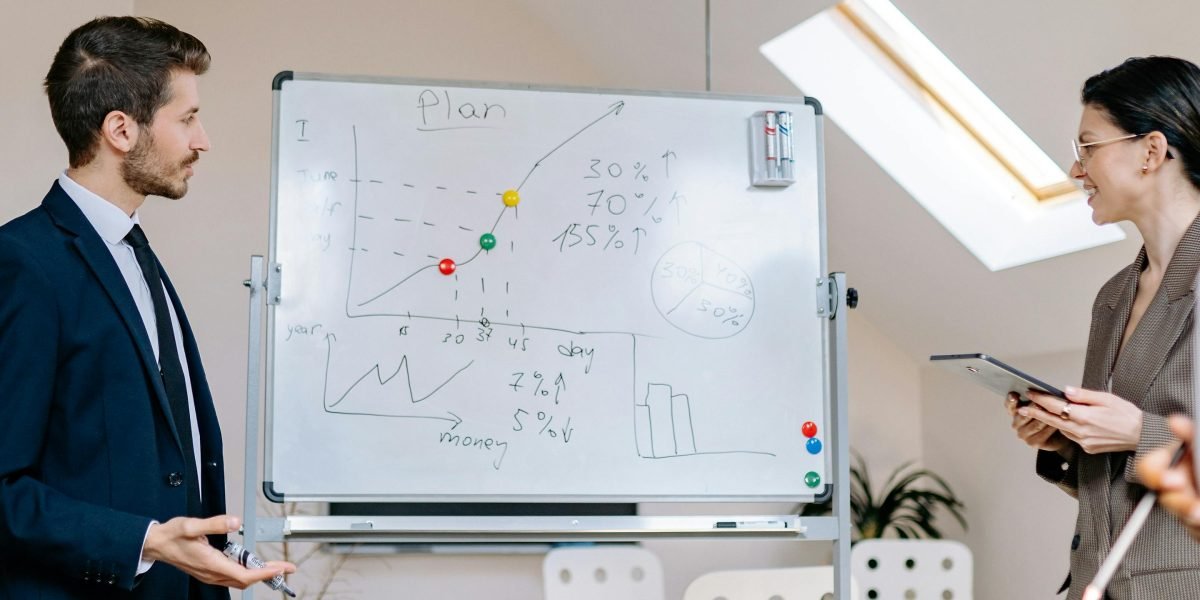 A group of professionals engaging in a focused discussion about investment strategies in a business meeting.