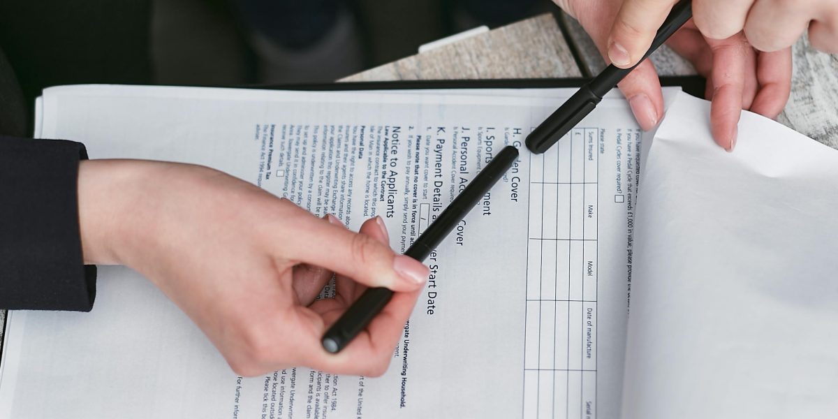 People thoroughly reviewing important contract documents.