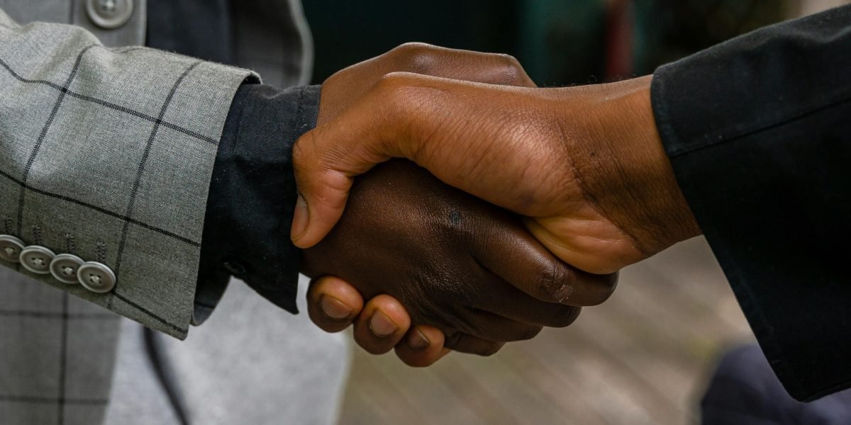 Professionals conclude a successful negotiation, symbolizing positive outcomes from wise choices in real estate.