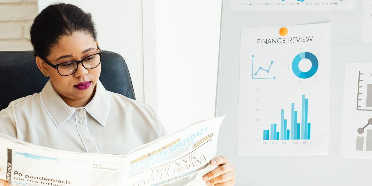A person carefully reviewing financial documents, symbolizing an investor focused on capital growth.