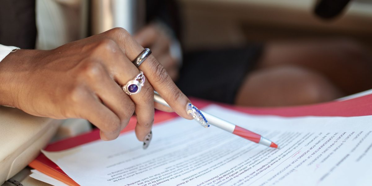 A professional carefully reviewing a contract or legal document, emphasizing attention to detail in agreements.