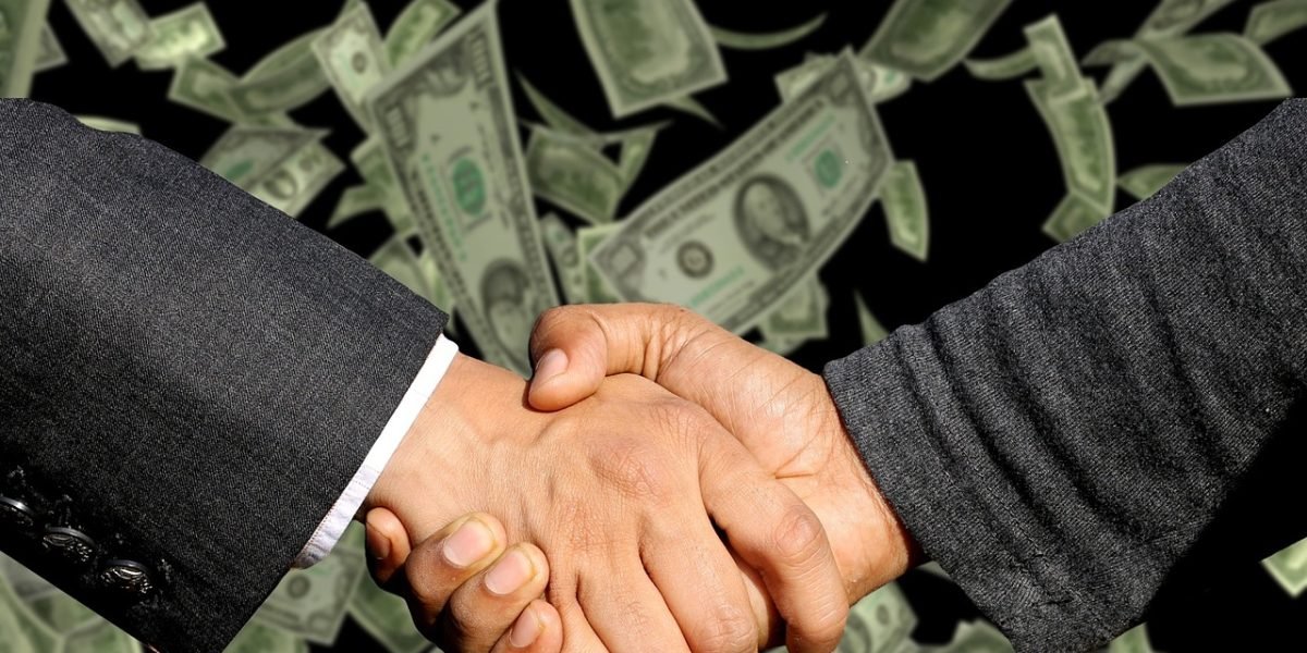 A moment of celebration or handshake, symbolizing the successful completion of a property transaction.